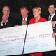 ITX Petroleum officials present a donation to arts programs for youths.